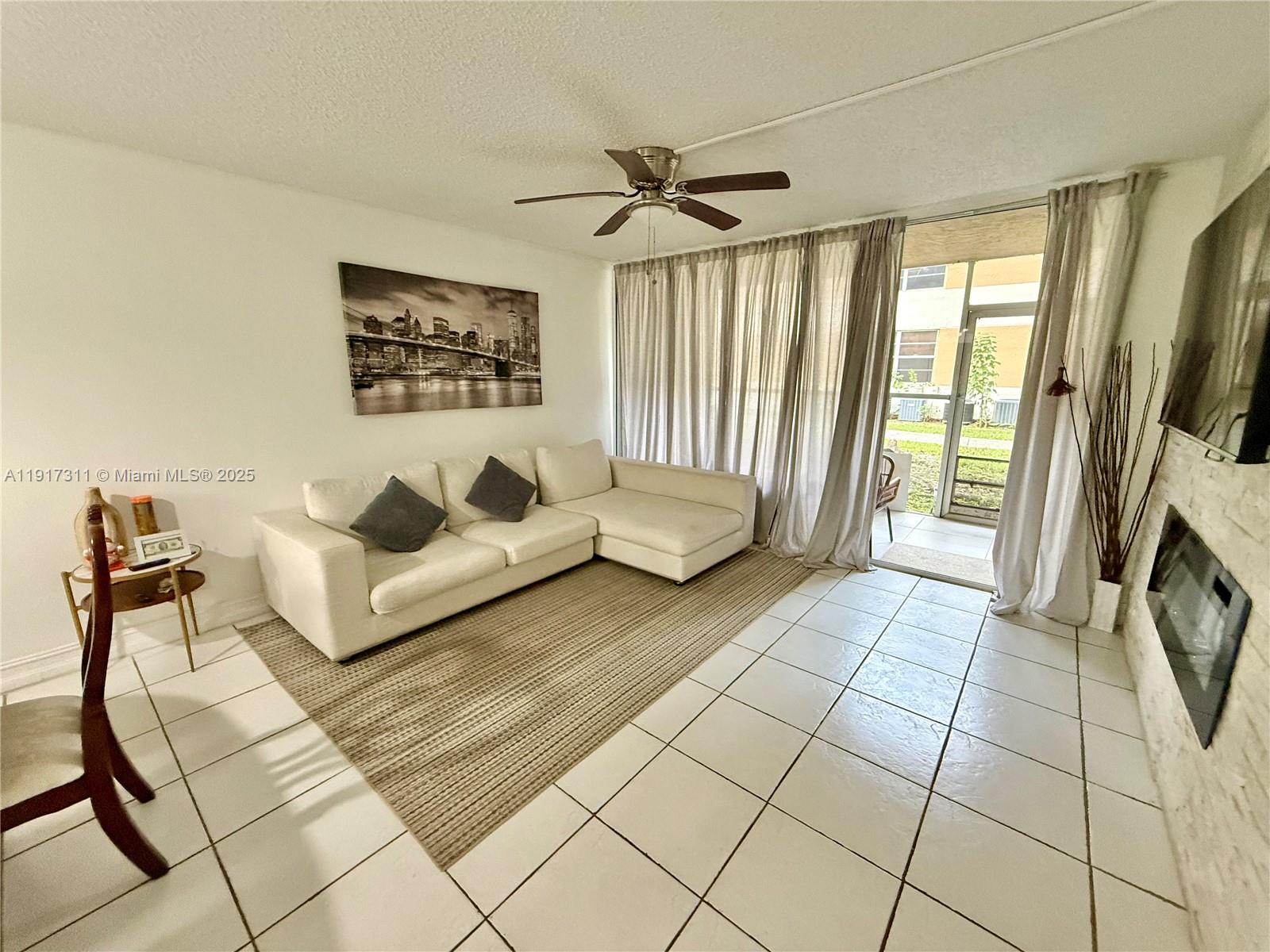 8246 Northwest 24th Street, Unit 8246 Coral Springs, FL 33065 - Photo 7 of 27 a spacious bedroom with a bed and a couch