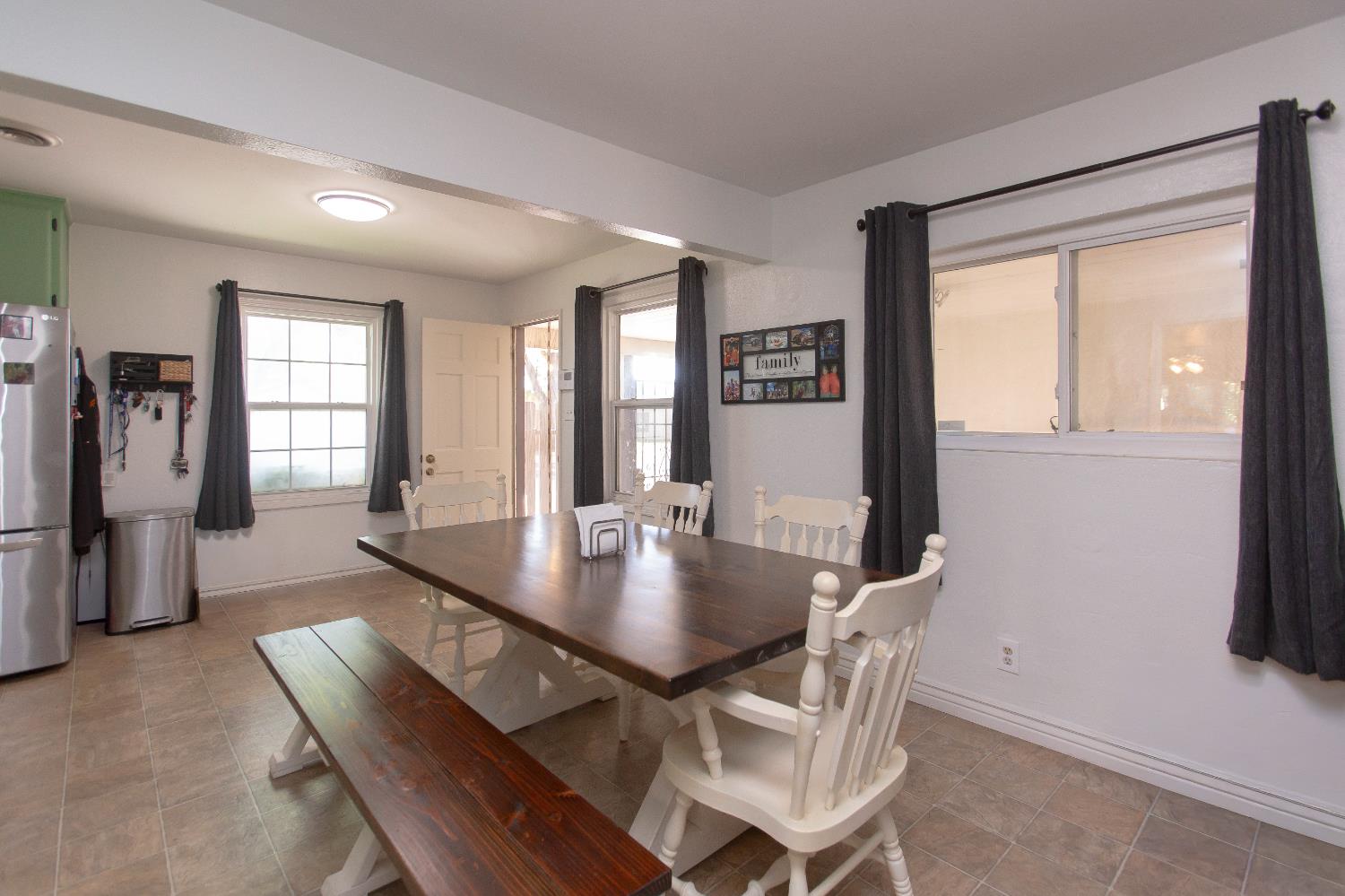 401 Fortuna Avenue Modesto, CA 95354 - Photo 13 of 43 a view of a dining room with furniture and window