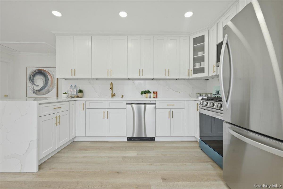 84 North Fordham Road Hicksville, NY 11801 - Photo 8 of 28 a kitchen with white cabinets and white appliances