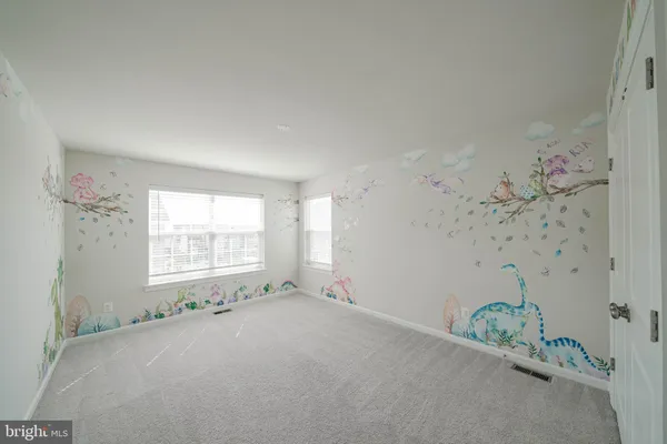 an empty room with windows and closet