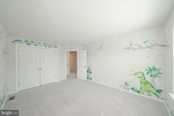 an empty room with an entryway and closet
