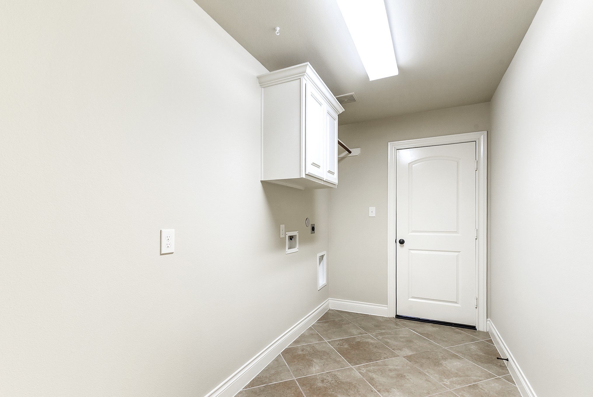 29023 Powder Ridge Drive Katy, TX 77494 - Photo 39 of 50 A spacious utility room provides plenty of room for an extra refrigerator and additional storage, if needed. The room features built-in cabinetry, a convenient hanging rod, and easy access to the 3-car garage.