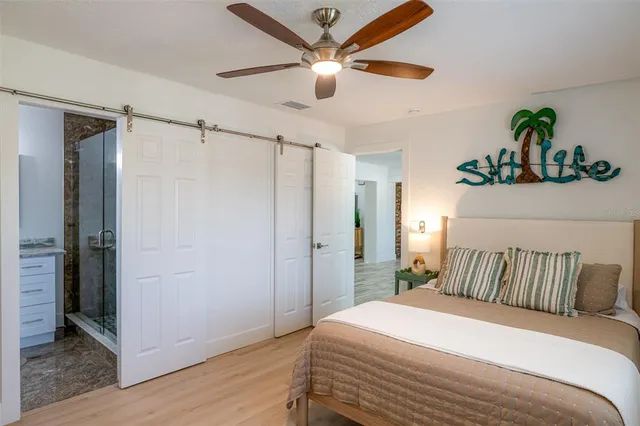 a bedroom with a bed and a ceiling fan