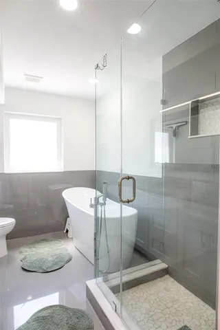 a bathroom with a granite countertop sink a toilet and a mirror