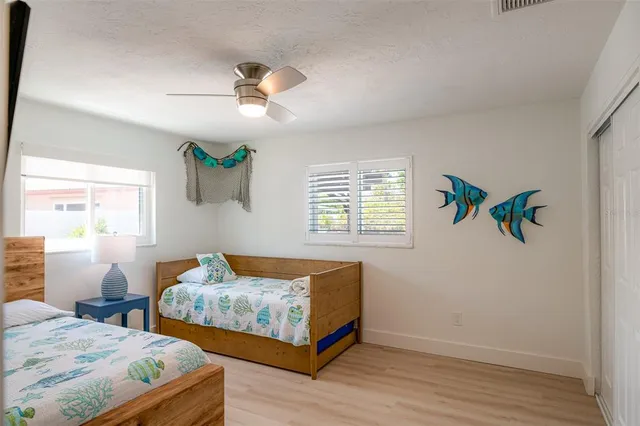 a bedroom with two beds and a window