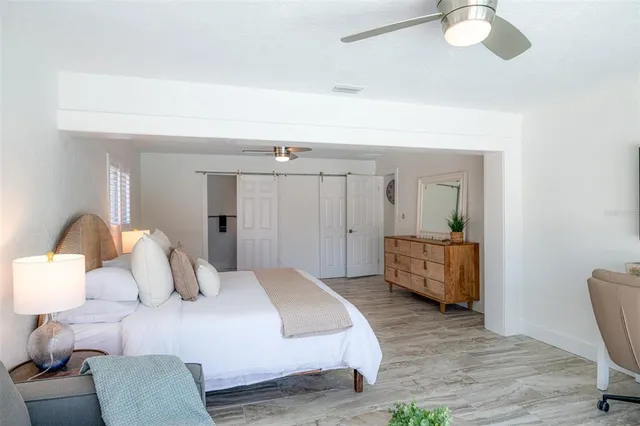 a bedroom with a bed and couches