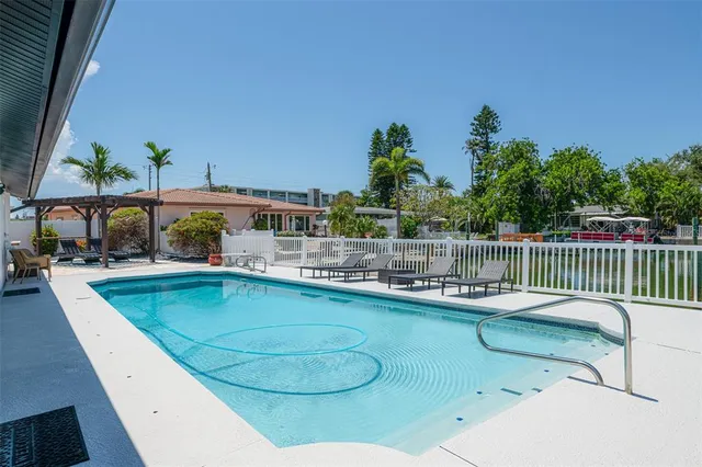a view of a house with swimming pool and sitting area