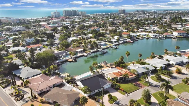 an aerial view of a houses with a lake