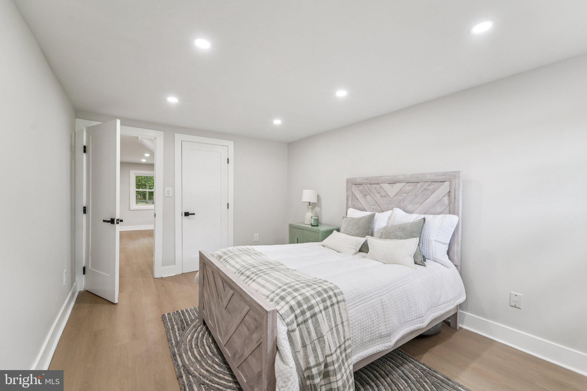 9168 Fort Smallwood Road Pasadena, MD 21122 - Photo 14 of 42 a bedroom with a bed and a walk in closet