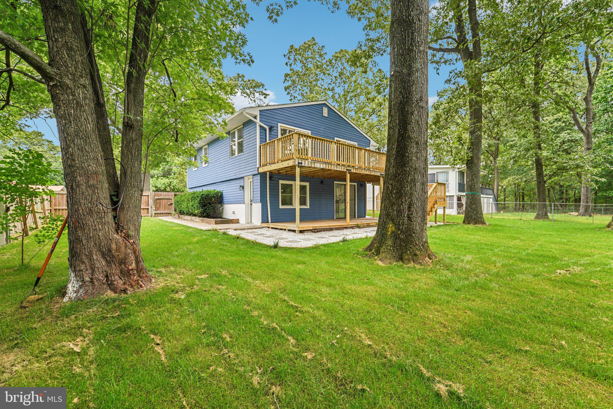 9168 Fort Smallwood Road Pasadena, MD 21122 - Photo 21 of 42 a house with green field in front of it
