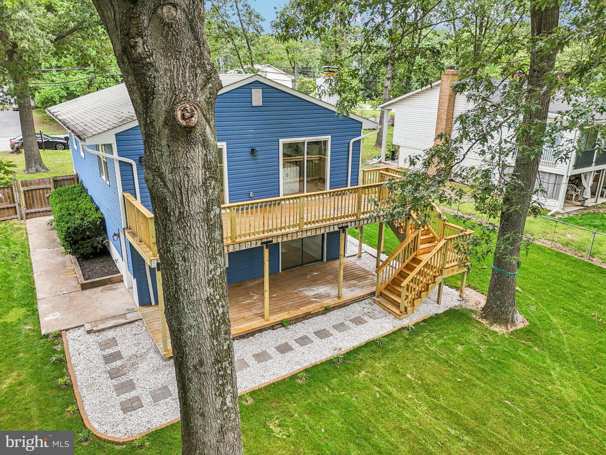 9168 Fort Smallwood Road Pasadena, MD 21122 - Photo 22 of 42 a house that has tree in front of it