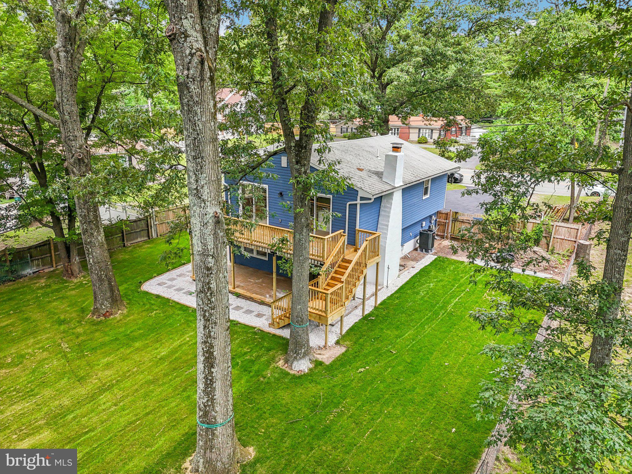 9168 Fort Smallwood Road Pasadena, MD 21122 - Photo 23 of 42 a view of a house with a backyard porch and sitting area