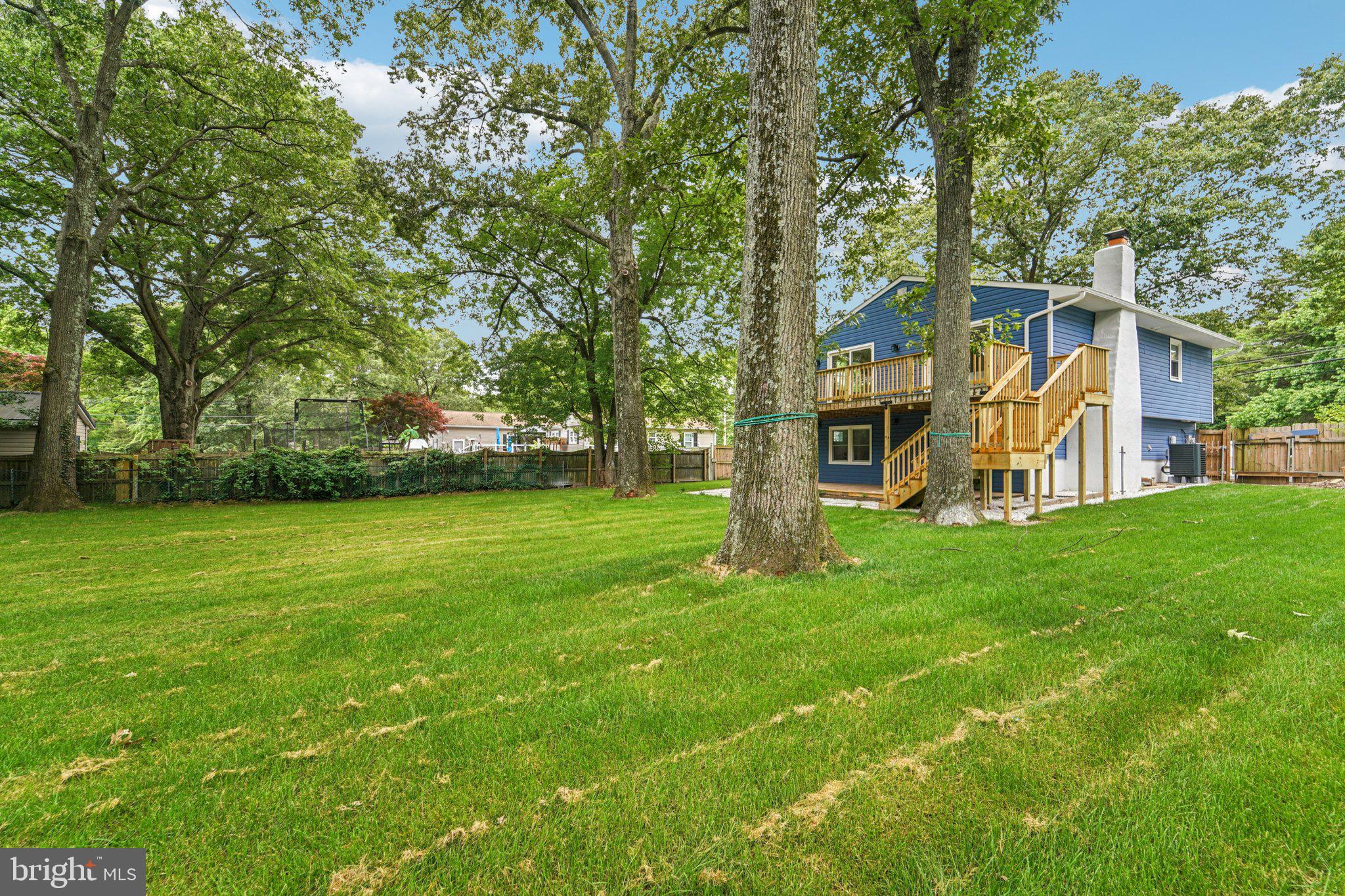9168 Fort Smallwood Road Pasadena, MD 21122 - Photo 28 of 42 a view of a house with a back yard