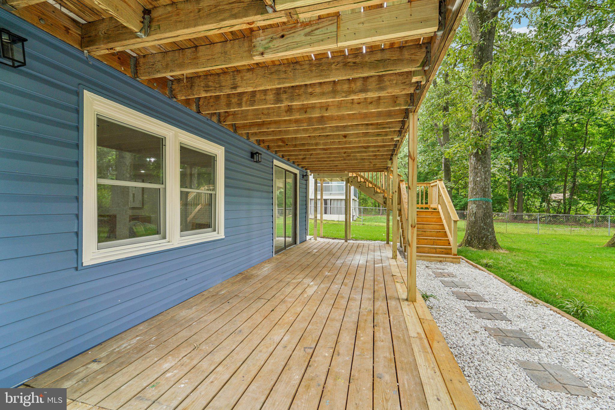 9168 Fort Smallwood Road Pasadena, MD 21122 - Photo 34 of 42 a view of backyard with a deck and wooden floor