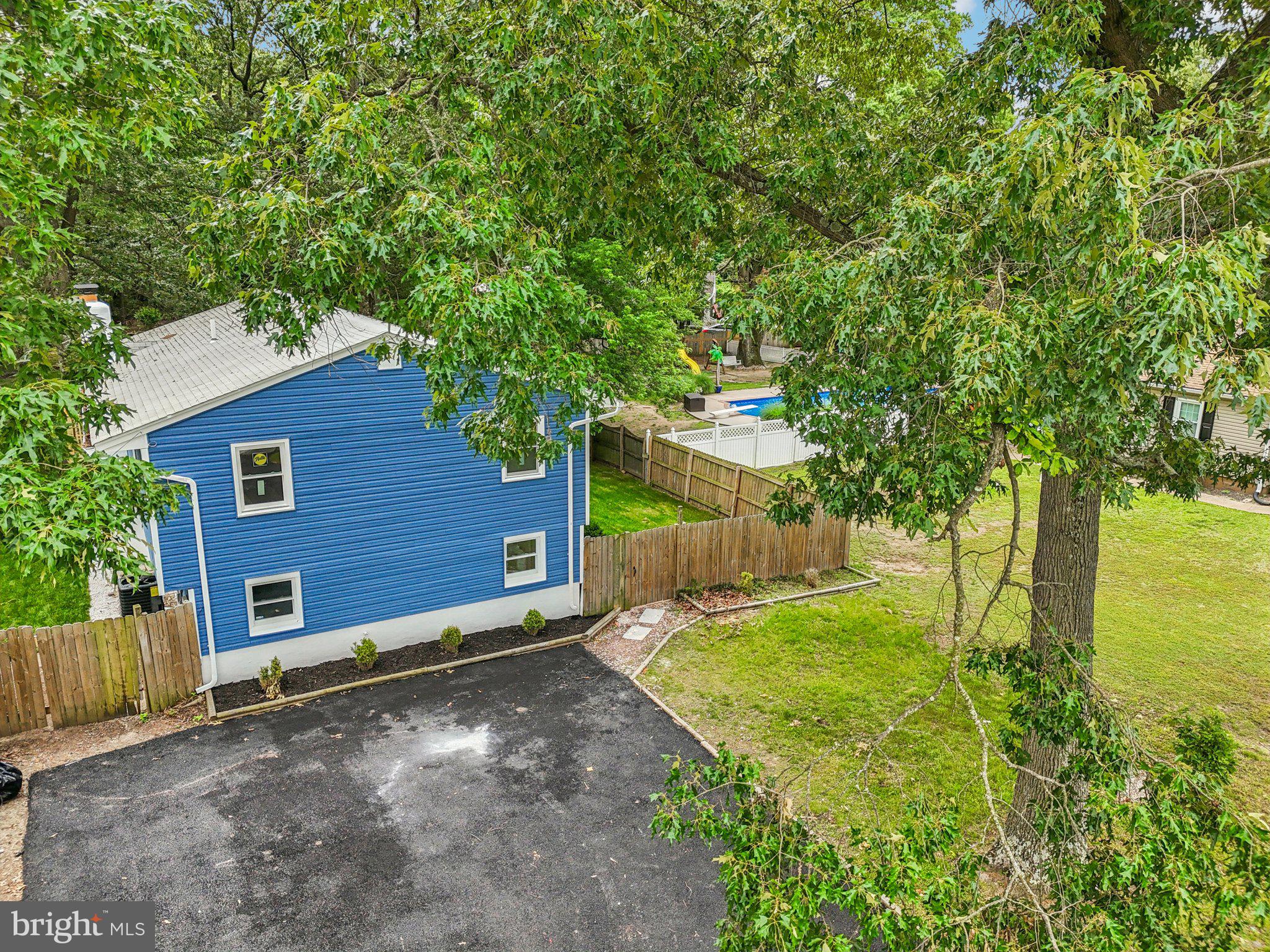 9168 Fort Smallwood Road Pasadena, MD 21122 - Photo 36 of 42 a view of a backyard with large trees