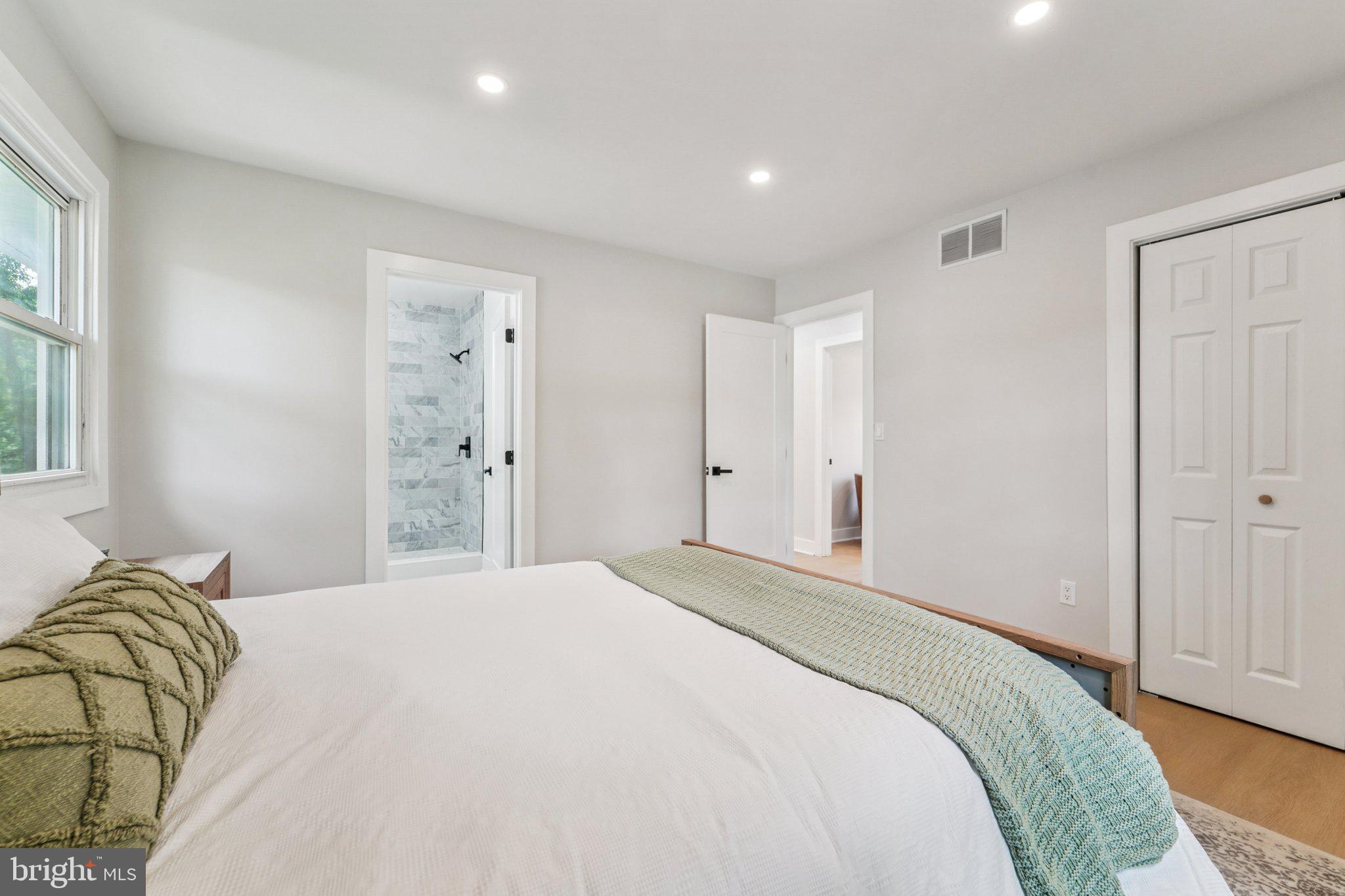 9168 Fort Smallwood Road Pasadena, MD 21122 - Photo 8 of 42 a bedroom with a bed and a window