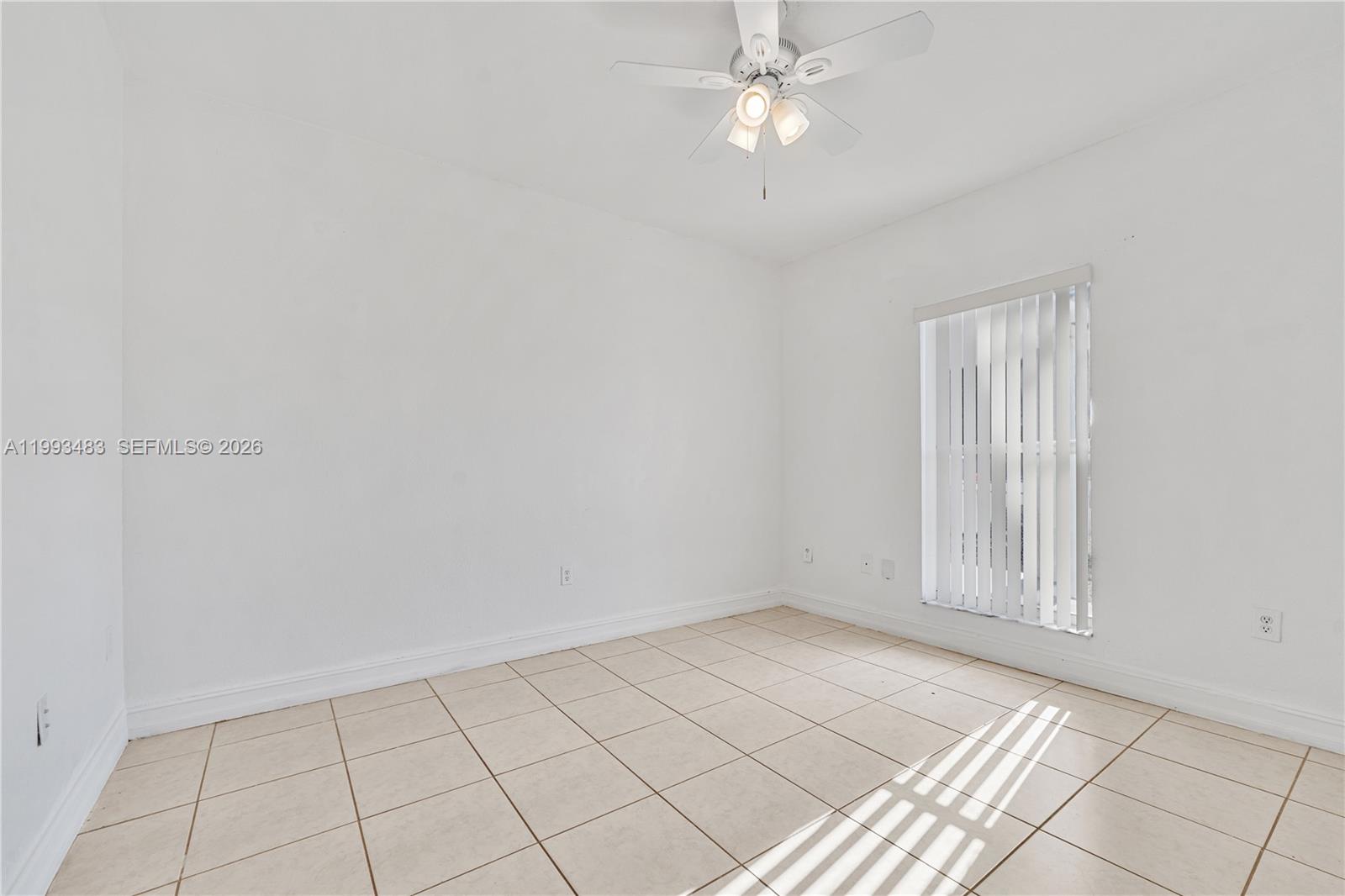 10357 Southwest 178th Street, Unit 10357 Miami, FL 33157 - Photo 23 of 25 an empty room with windows and fan