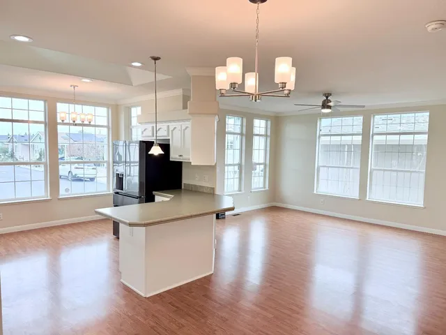 a large kitchen with kitchen island a sink stainless steel appliances and cabinets