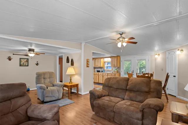 a living room with furniture and a chandelier