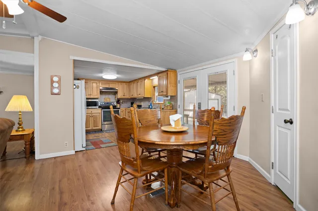 a view of a dining room with furniture and wooden floor