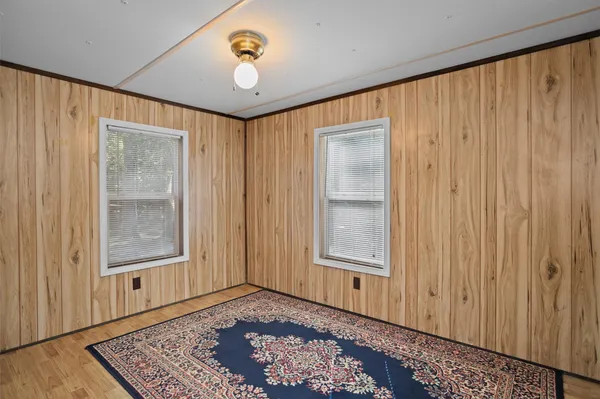 an empty room with windows and closet