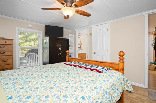 a bedroom with a bed and a television