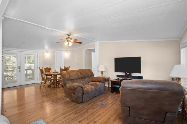 a living room with furniture and a flat screen tv