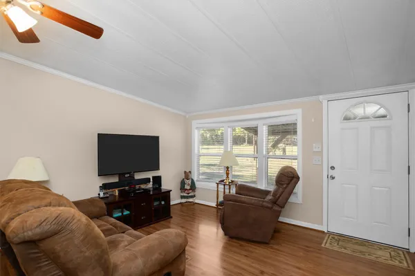 a living room with furniture and a flat screen tv
