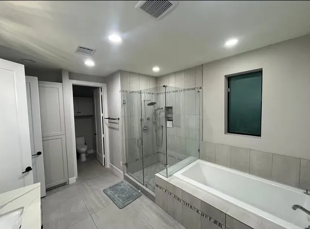 a bathroom with a bathtub and a shower
