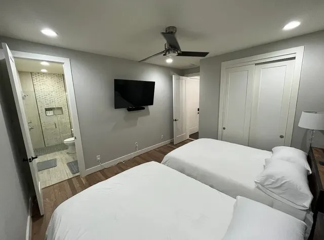 a bedroom with a large bed and a flat screen tv