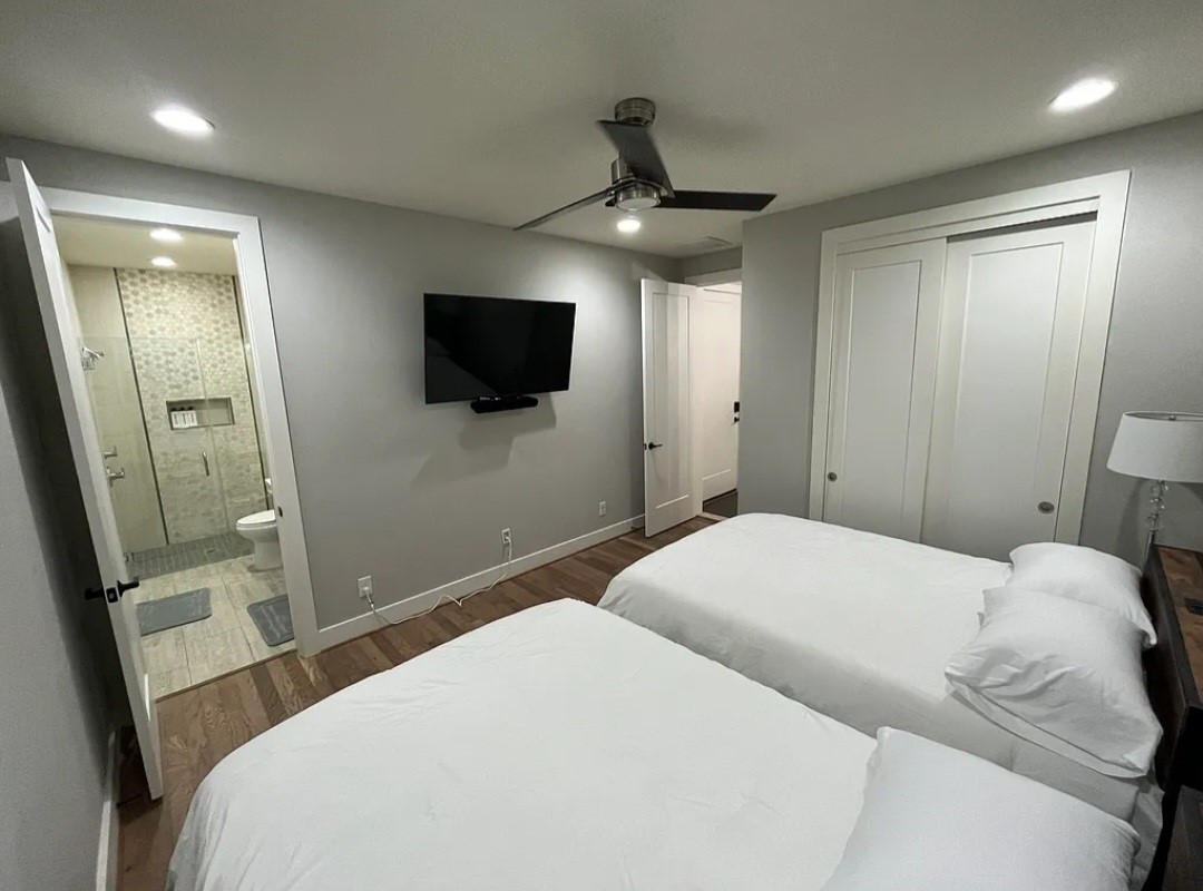 1503 Robin Street, Unit C Houston, TX 77019 - Photo 9 of 18 a bedroom with a large bed and a flat screen tv