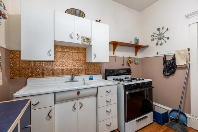 a kitchen with a refrigerator sink and cabinets