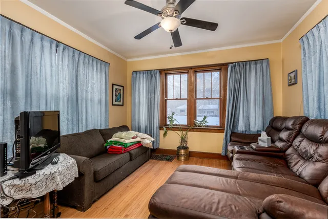 a view of a dining room with furniture and chandelier