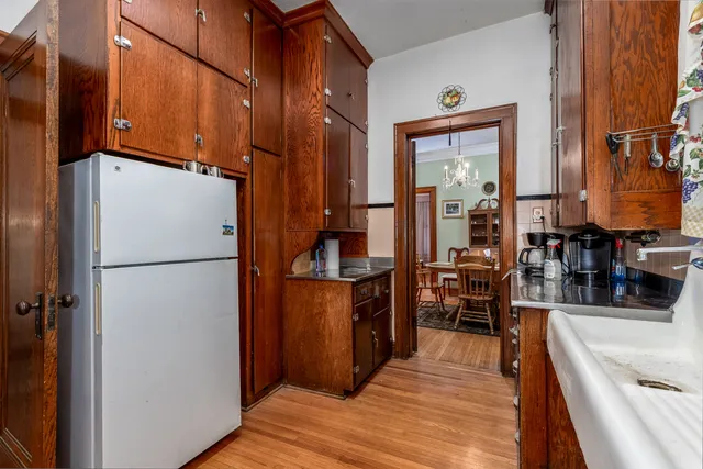 a living room with a bed and a chandelier