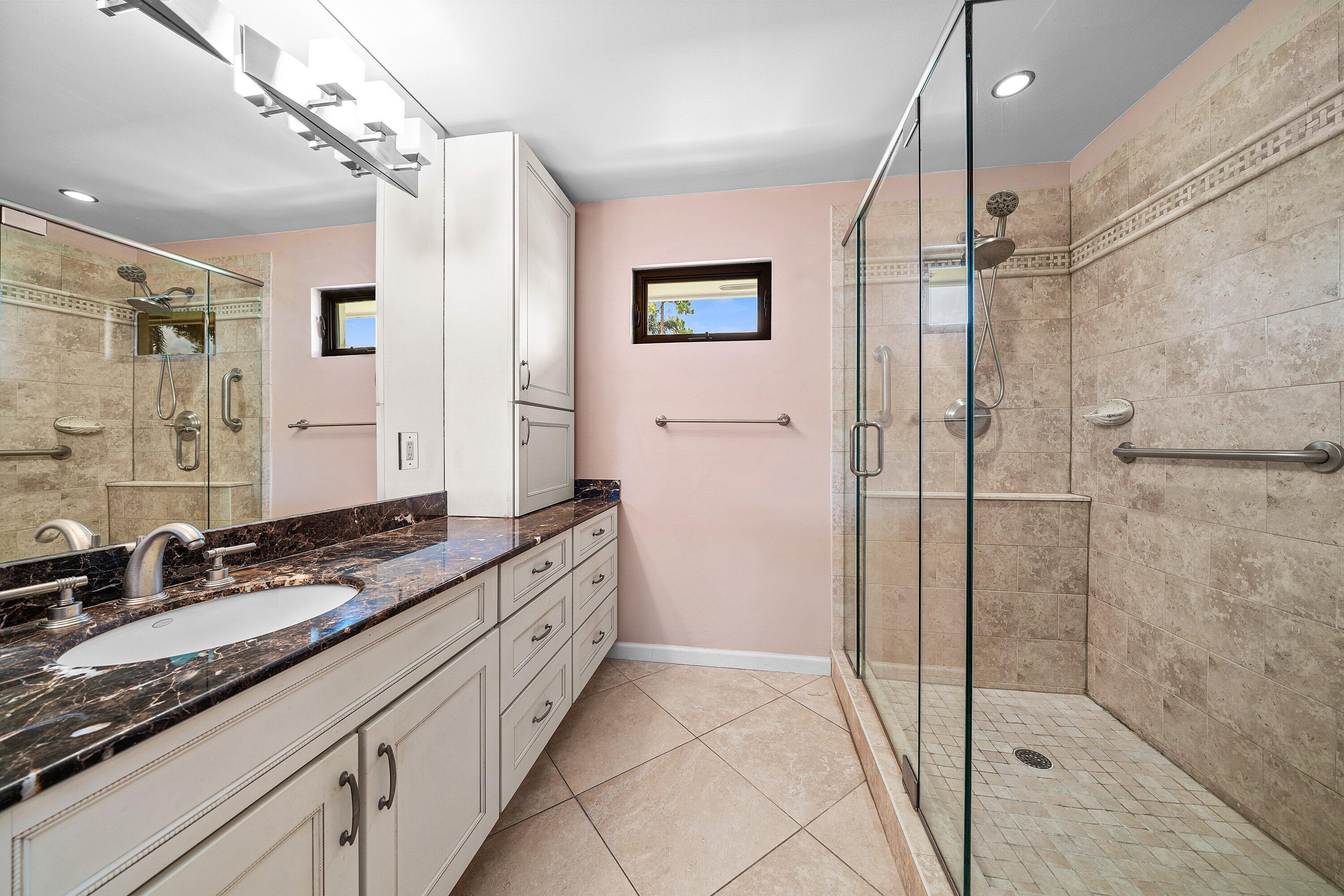 4365 Shell Drake Lane Boynton Beach, FL 33436 - Photo 22 of 56 a bathroom with a granite countertop sink a mirror a shower and a bathtub
