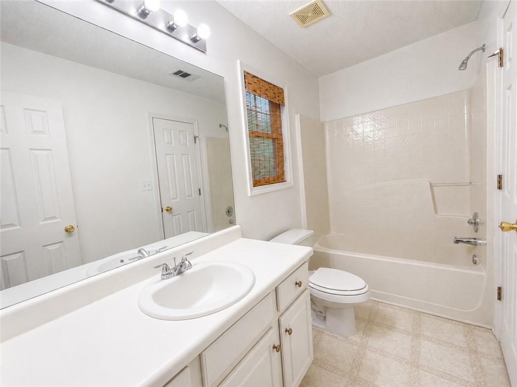 6936 Red Bone Way Stonecrest, GA 30038 - Photo 9 of 17 a bathroom with a sink toilet tub and shower