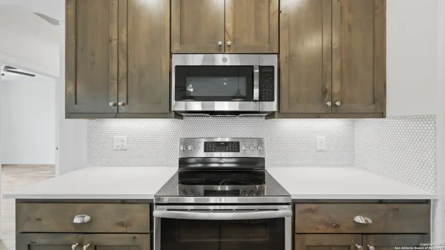 a kitchen with a sink stove and refrigerator