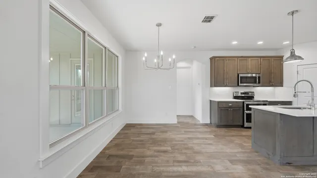 a view of an empty room with a window and a ceiling fan