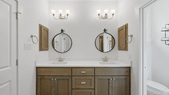 a bathroom with a double vanity sink and a mirror