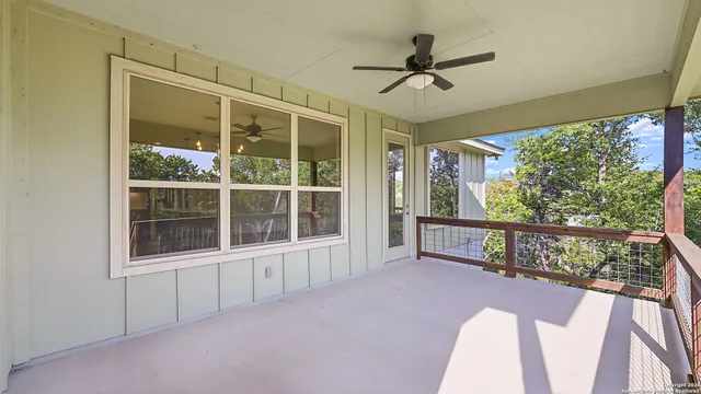 a view of porch with a flat tv screen and a floor to ceiling window
