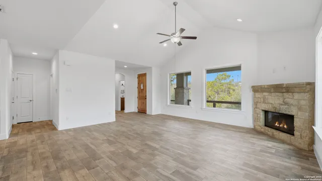 a view of an empty room with window and fire place