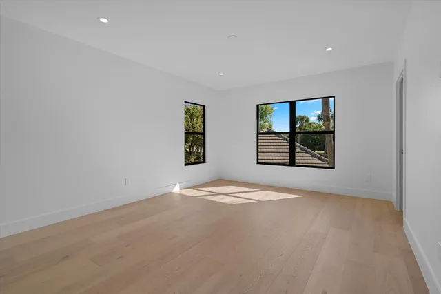 a view of an empty room with a window and fireplace