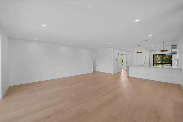 a view of a kitchen with a sink and a refrigerator