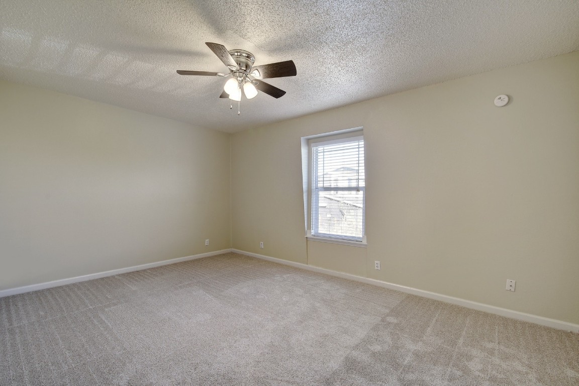 1704 East M. Franklin Avenue, Unit C Austin, TX 78721 - Photo 11 of 18 an empty room with windows and fan