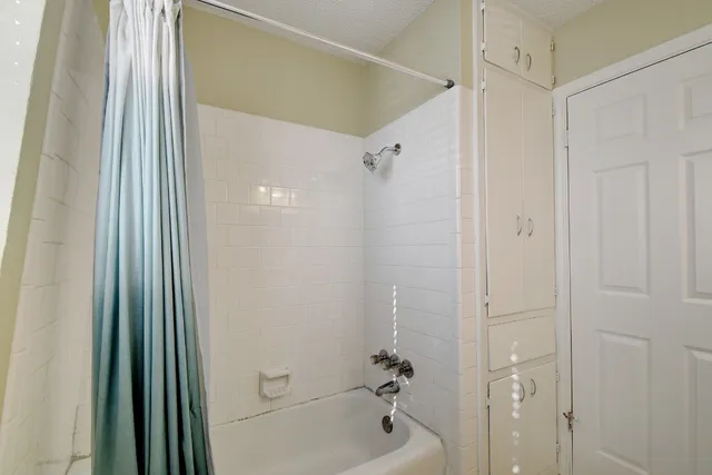 a bathroom with a shower and a tub