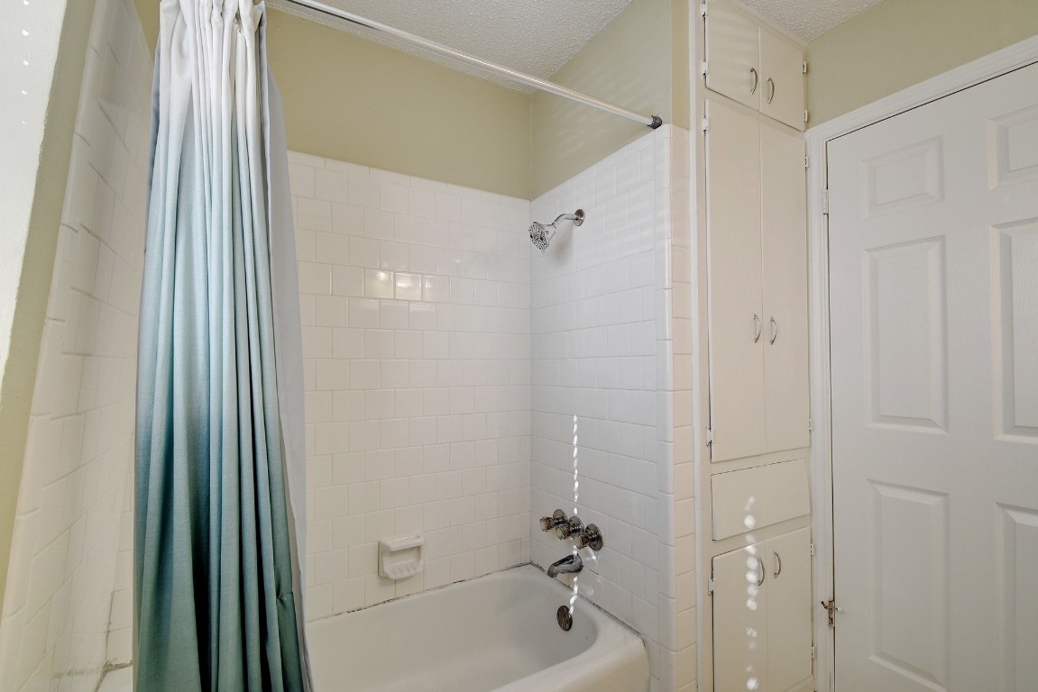 1704 East M. Franklin Avenue, Unit C Austin, TX 78721 - Photo 13 of 18 a bathroom with a shower and a tub