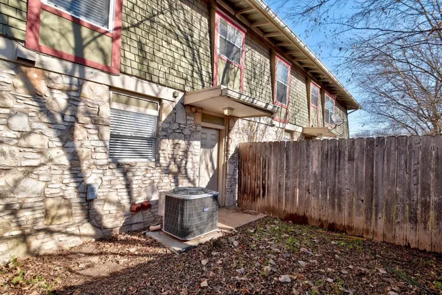 a view of a backyard with wooden fence