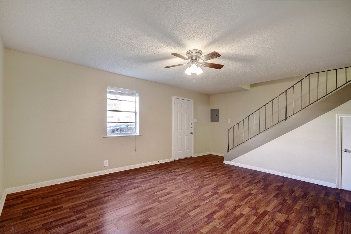 1704 East M. Franklin Avenue, Unit C Austin, TX 78721 - Photo 2 of 18 a view of an empty room with a window and wooden floor