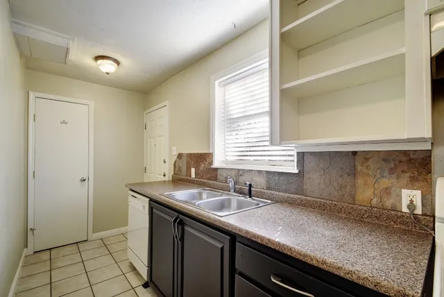 a kitchen with a sink and a window