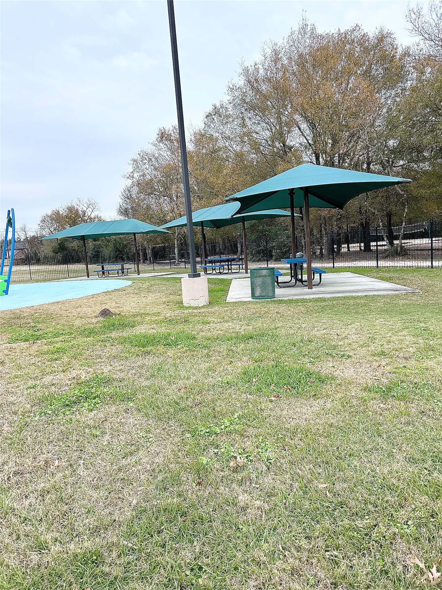 3300 Pebblebrook Drive, Unit 75 Seabrook, TX 77586 - Photo 27 of 30 a view of a swimming pool with a table and chairs under an umbrella